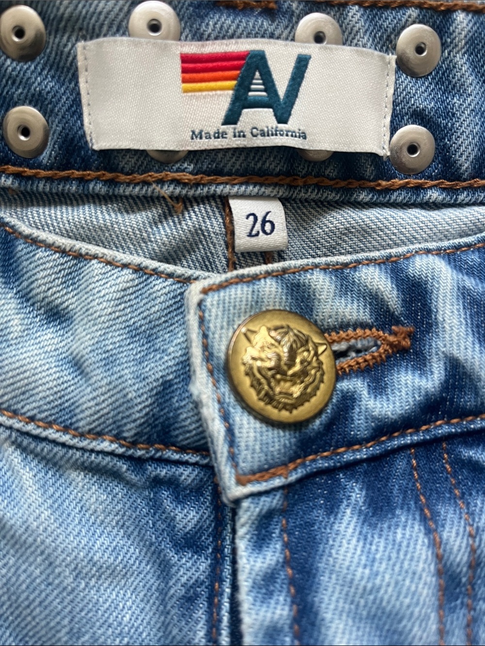 Aviator Nation Light Blue distressed Jean shorts with red bolt.
